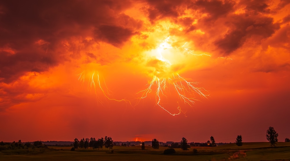 orange clouds with lightning strikes