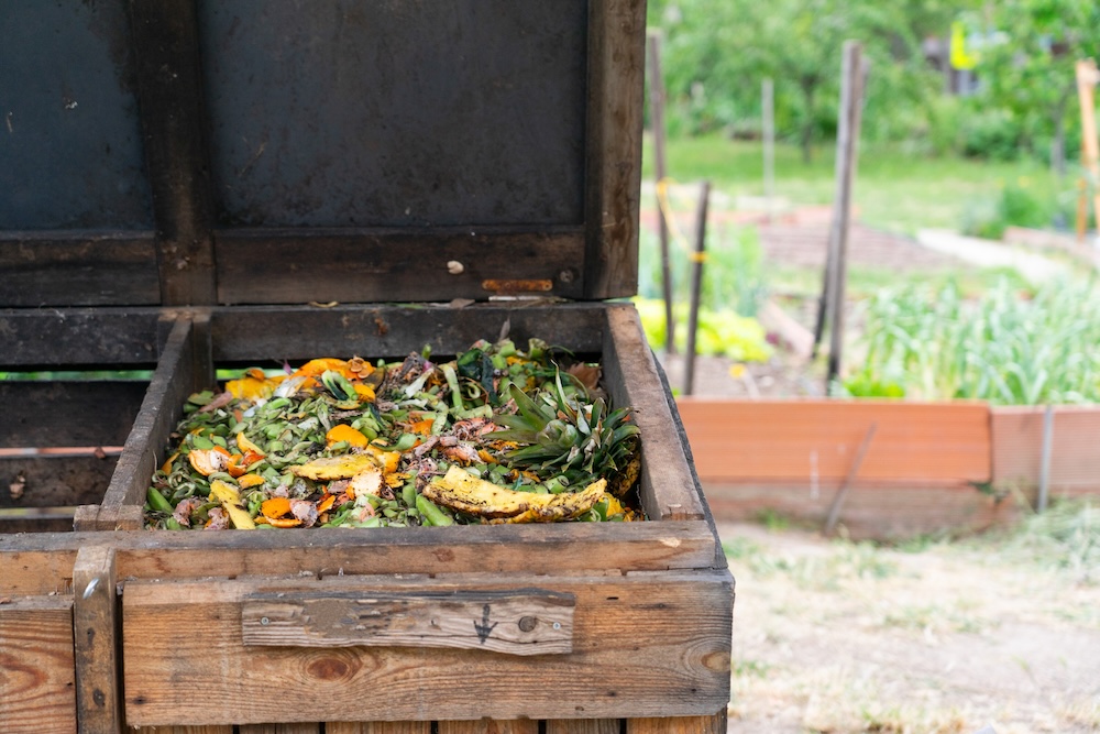 outdoor wooden compost bin in garden