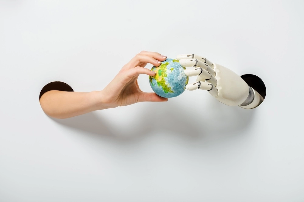 human hand and robot handing holding earth together