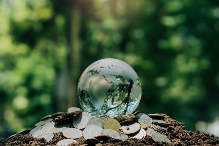 earth made out of crystal sitting on coins in outside