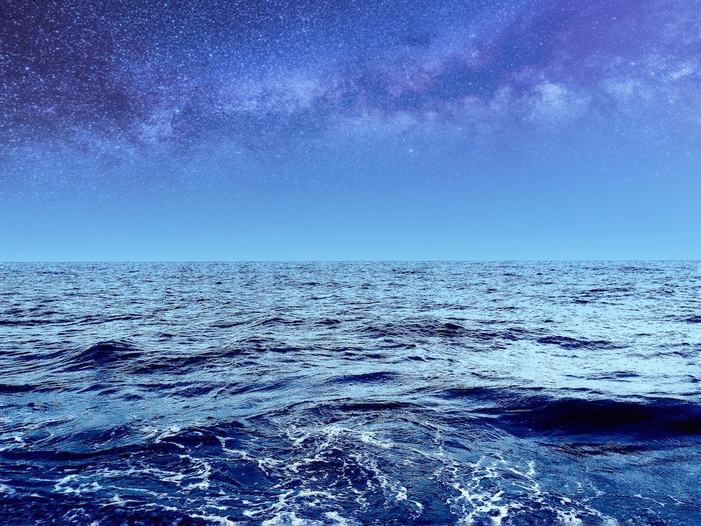 ocean at night with a starry sky