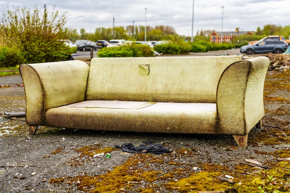 old couch dumped illegally and will end up in landfill