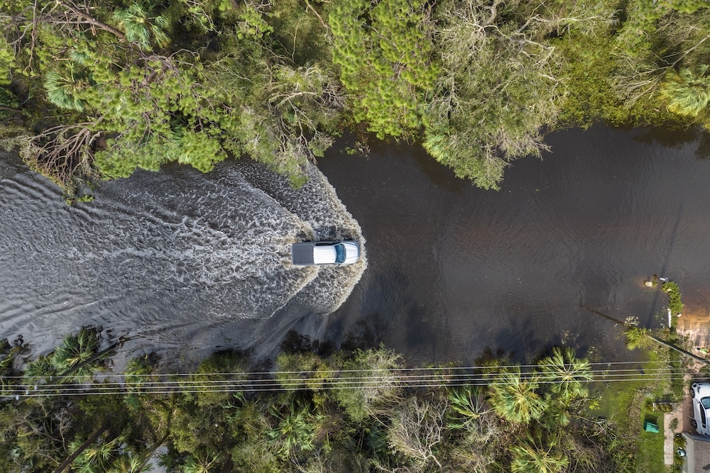 truck driving through flooding caused by hurricane