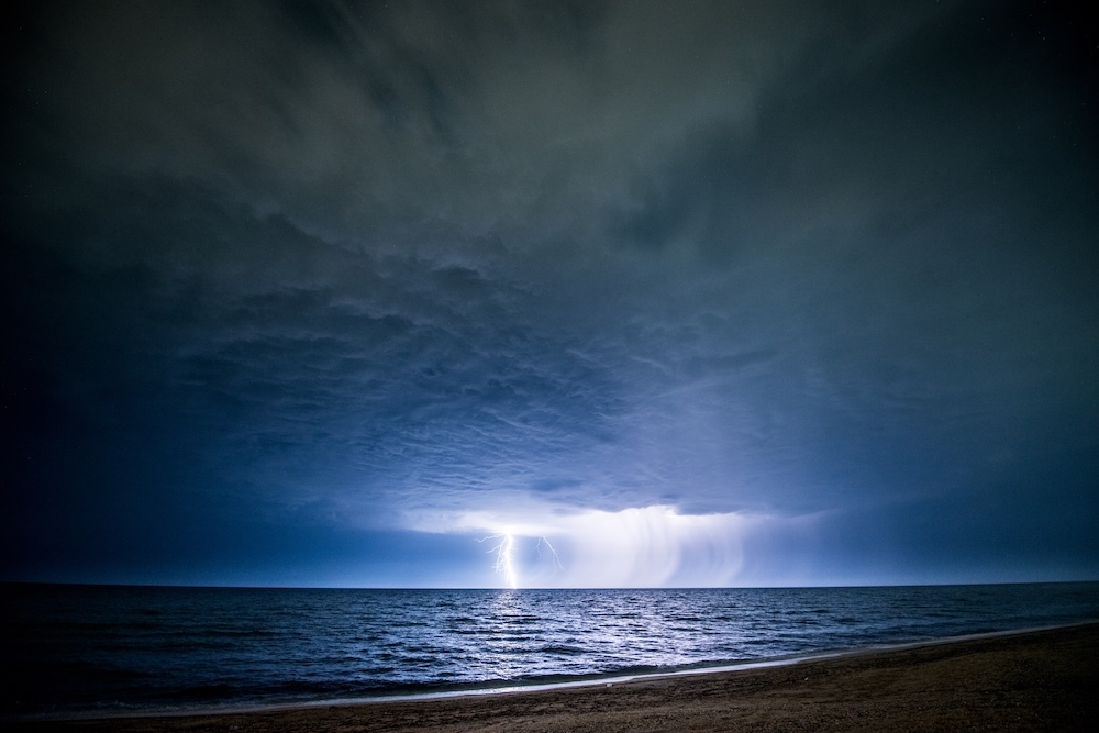 lightening over ocean waters at night