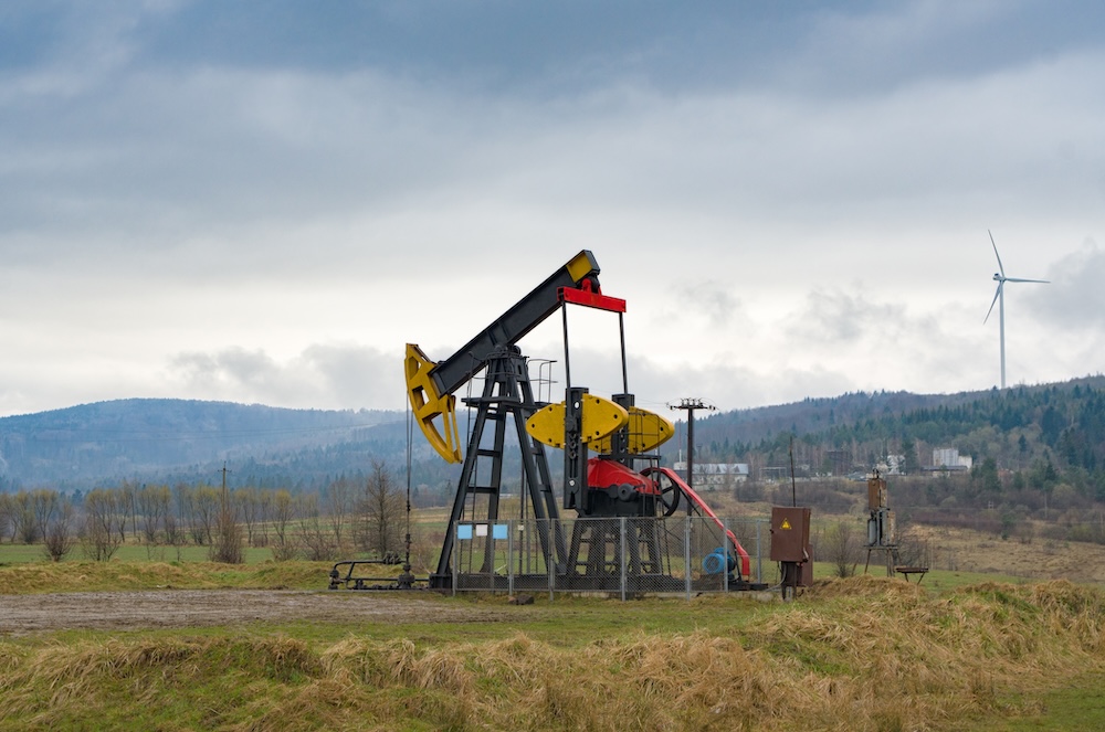 oil and gas pump with mountains in the distance