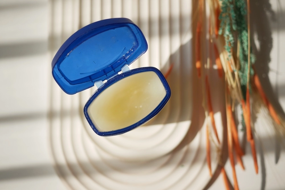 Petroleum jelly in a blue plastic container