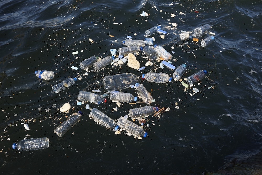 plastic bottles and garbage wate floating in the sea