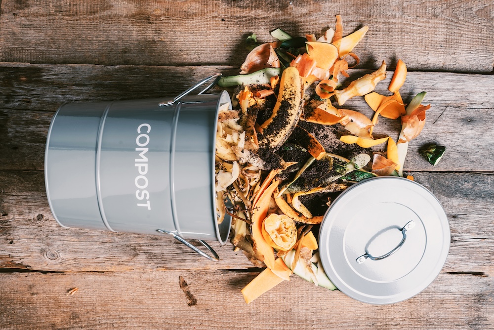 metal compost bin with composting spilling out