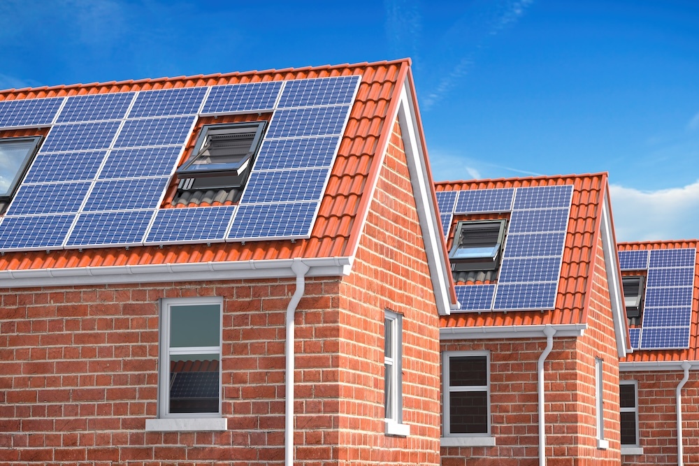 row of houses with solar panels on the rooftop