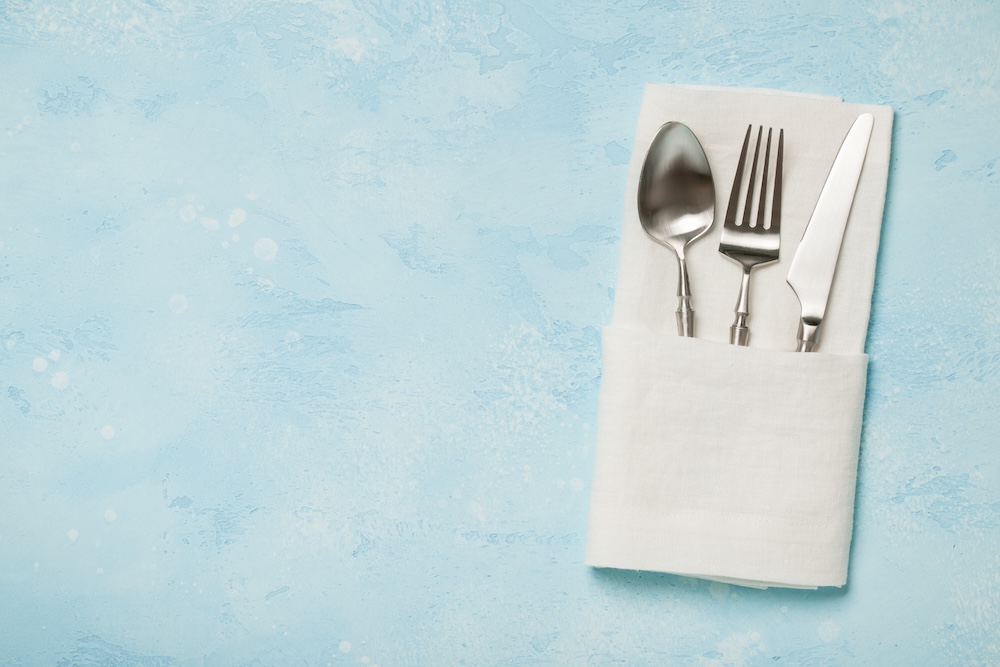 Silver cutlery in a folded napkin