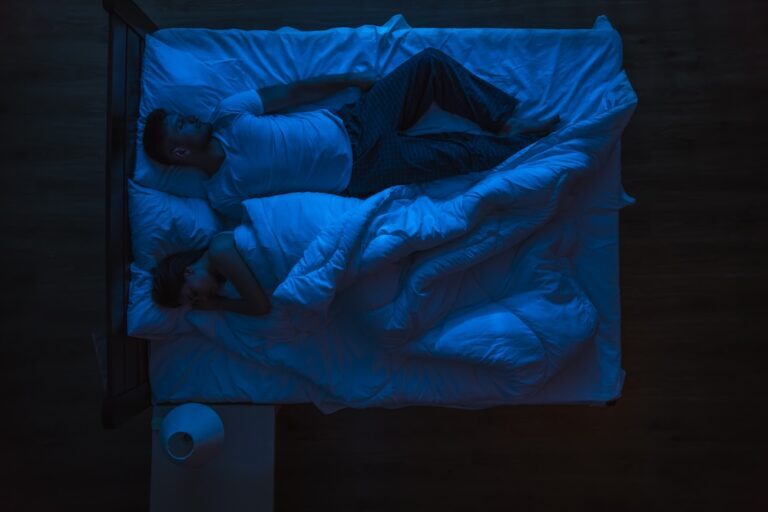 Man and woman asleep at night
