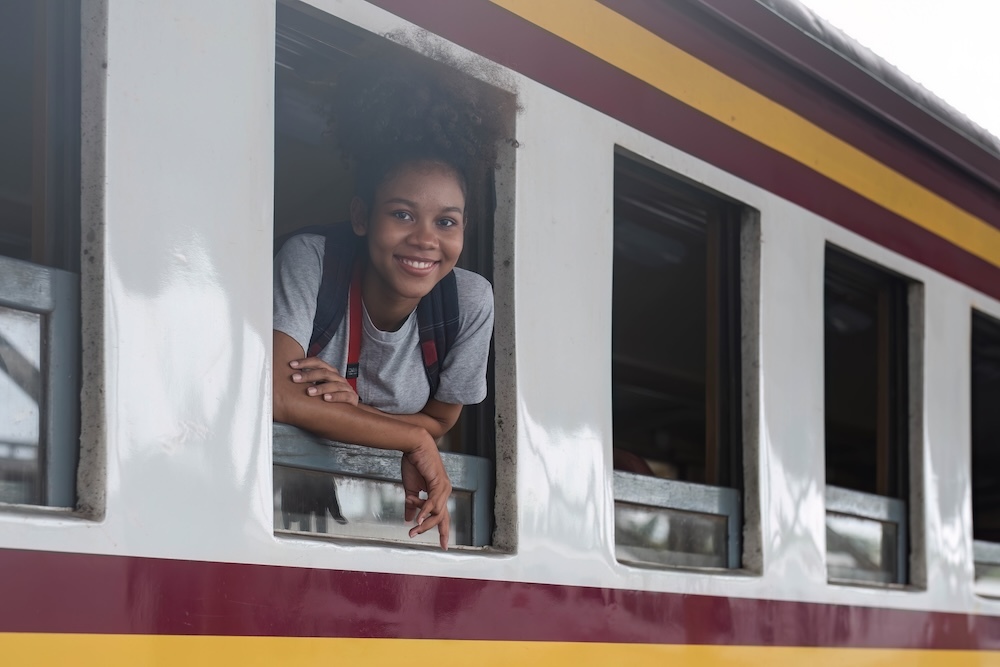 Young woman looking out of her seat window on a train