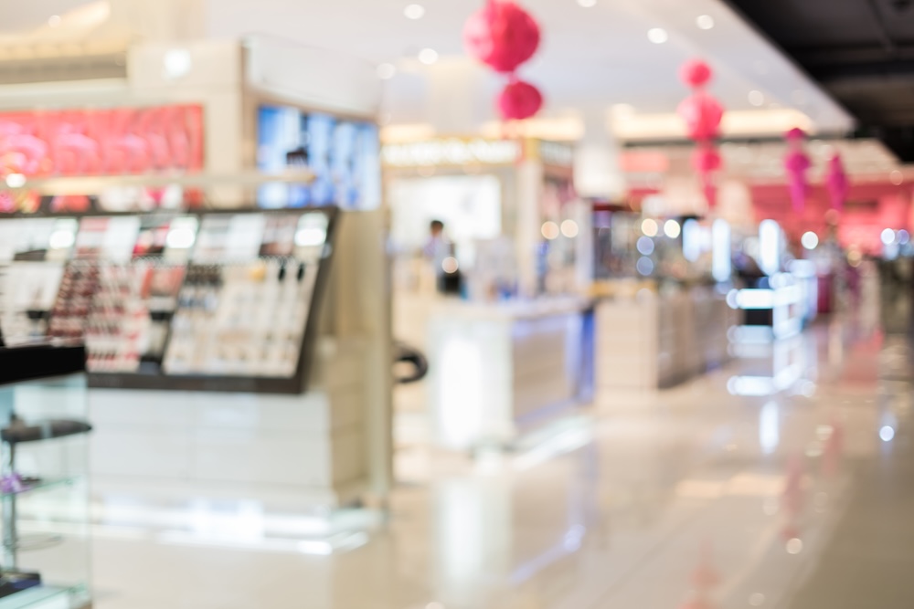 blurred image of a makeup counter at the mall