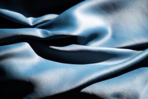 Blue silk texture on a black background