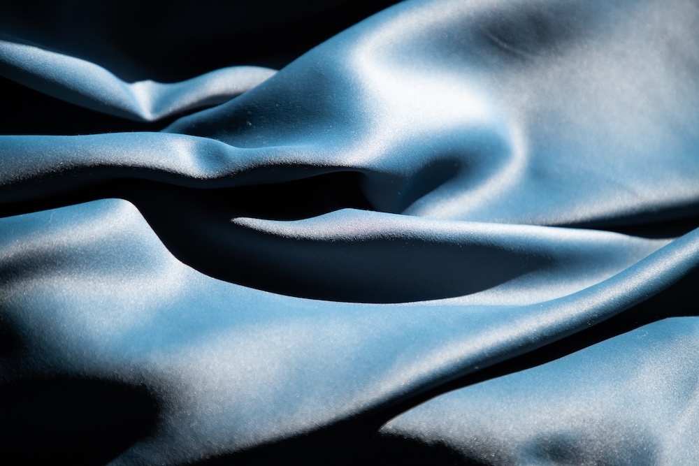 Blue silk texture on a black background
