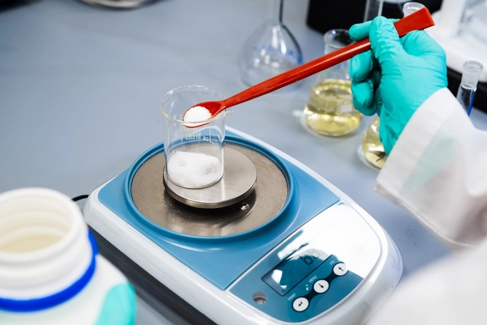 Woman weighing powder preservatives