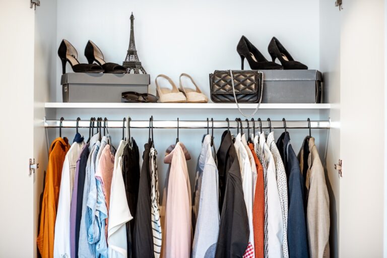 Shoes and clothing in wardrobe at home