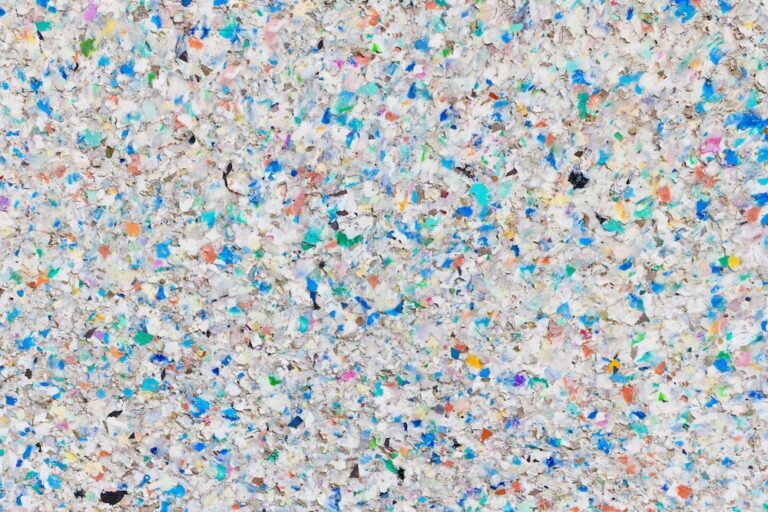 Shredded plastic formed into a board