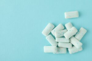 Pieces of chewing gum on a blue background