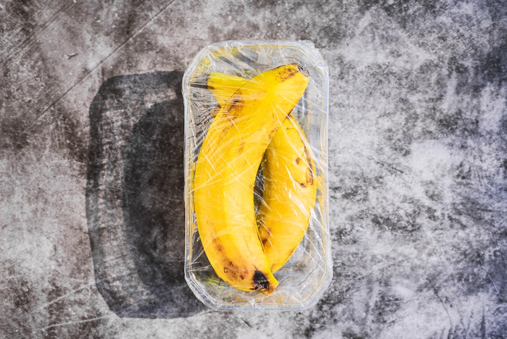 Bananas wrapped in plastic