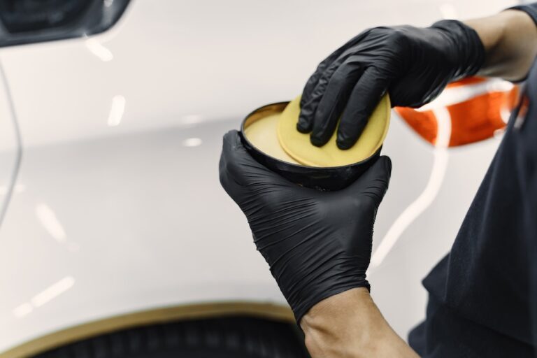 man using wax in a tin to polish