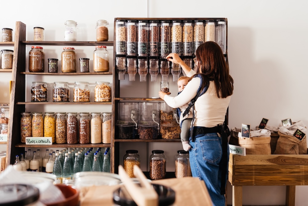 Mother shopping in a zero waste store using circular packaging