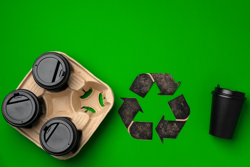 black recycle sign with coffee cups