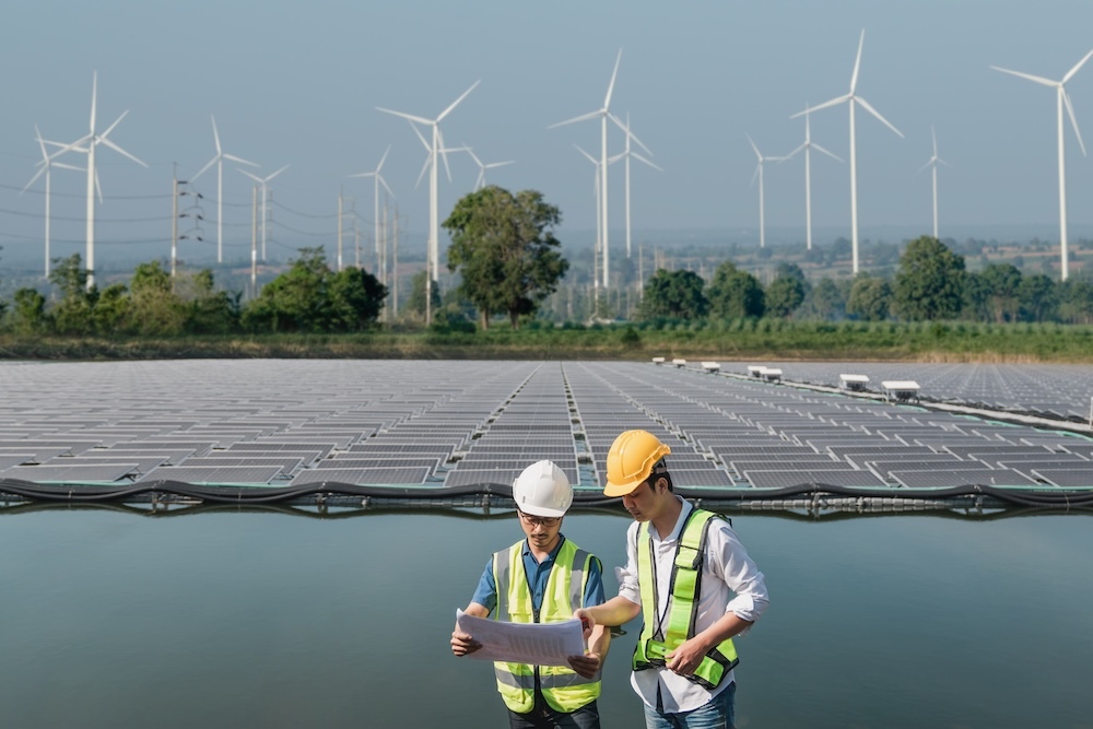 Solar engineers servicing solar panel cells