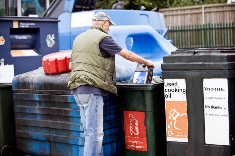 A man recycling oil in correct bins