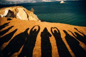Happy people silhouettes in the sand