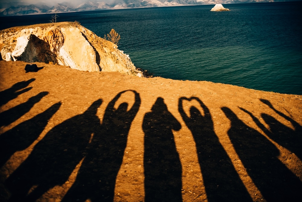 Happy people silhouettes in the sand