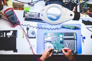 Person repairing a laptop