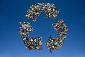 Recycled tin cans in shape of recycling symbol