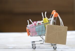 Miniture cart with multi-color shopping bags inside