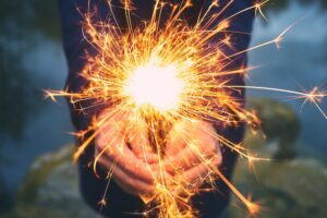 woman holding a sparkler outdoors
