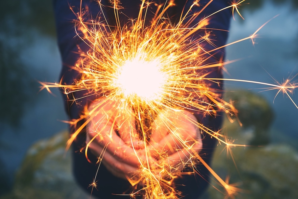 woman holding a sparkler outdoors