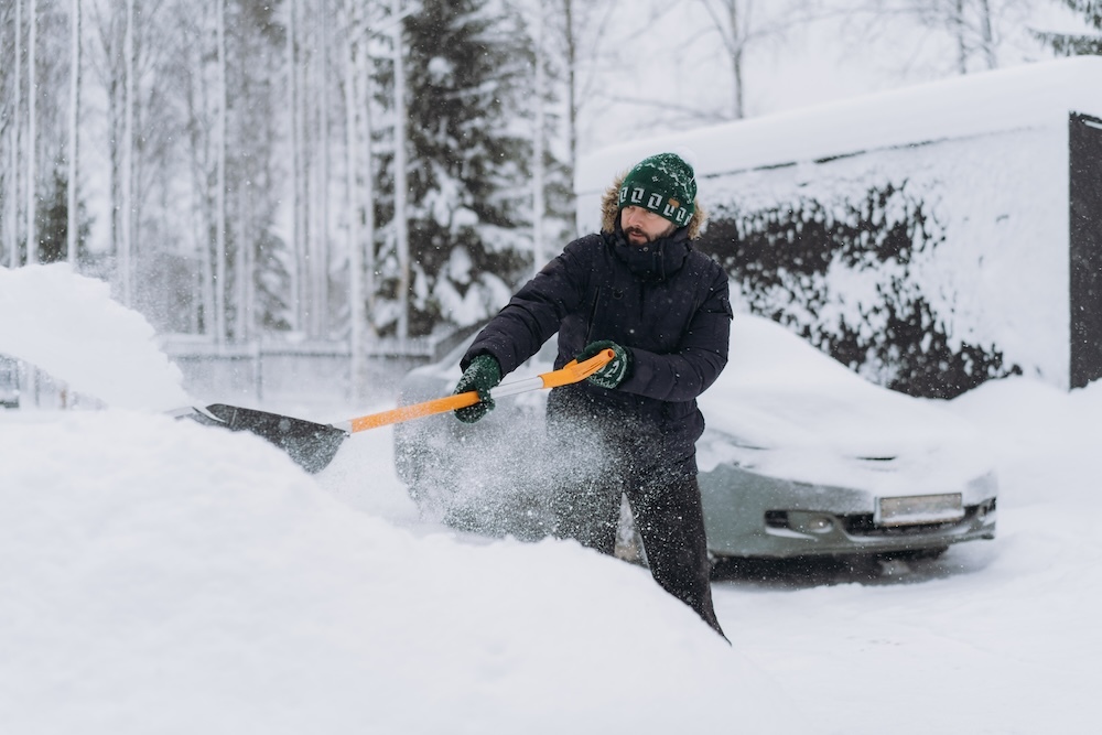 Man shoveling snow out of his driveway
