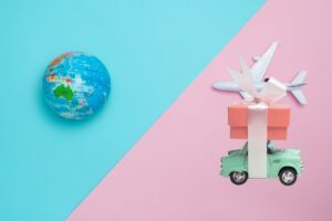 Earth and airplane and car on a blue and pink background