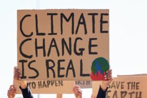 Person holding climate change is real