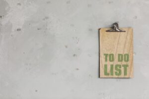 green words spelling to do list on a wooden board