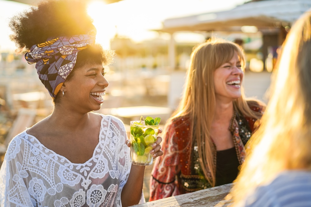 happy multiracial women sitting together