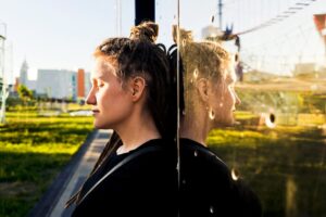 woman self reflecting in mark against a reflective building