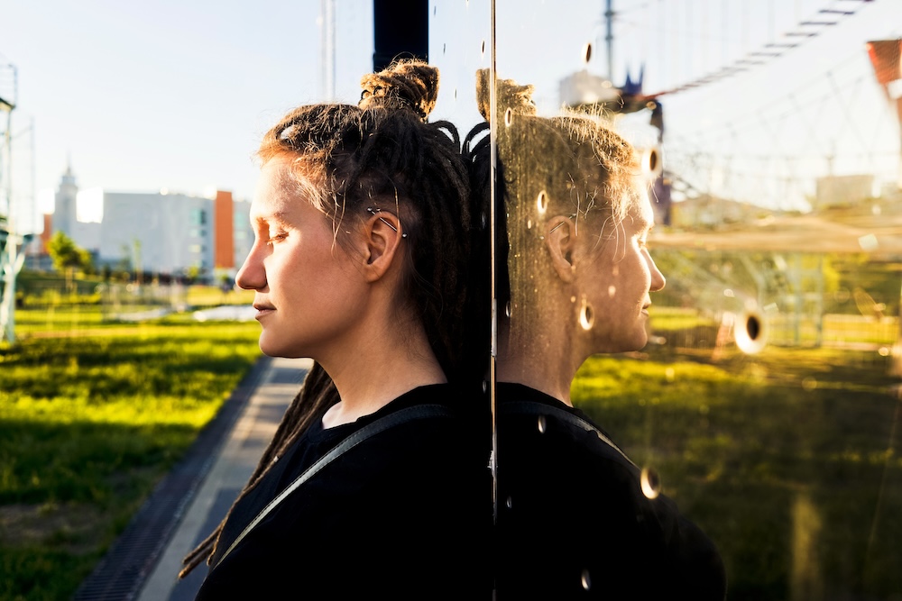 woman self reflecting in mark against a reflective building