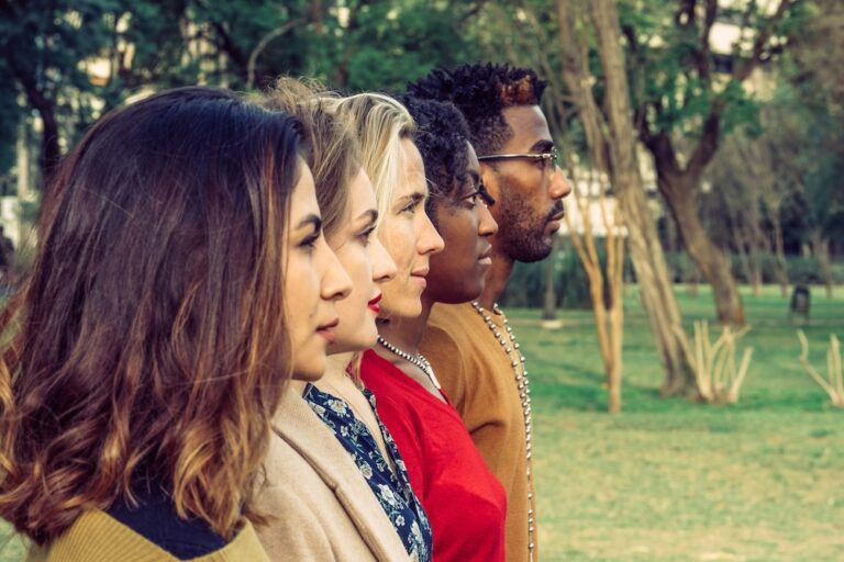 Side profiles of different men and women standing in a row
