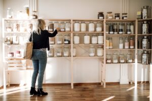Young woman buying groceries in a zero waste shop