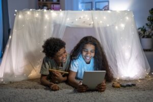 young children playing on a tablet
