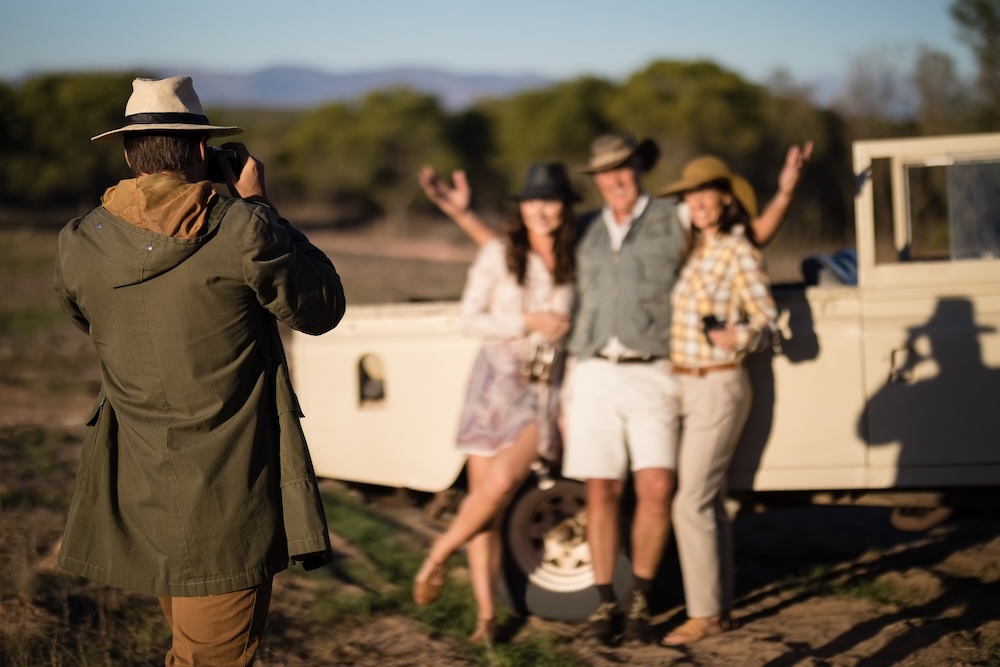 Person taking picture of friends on a safari vacation
