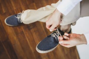 Man tying eco flax blue shoes