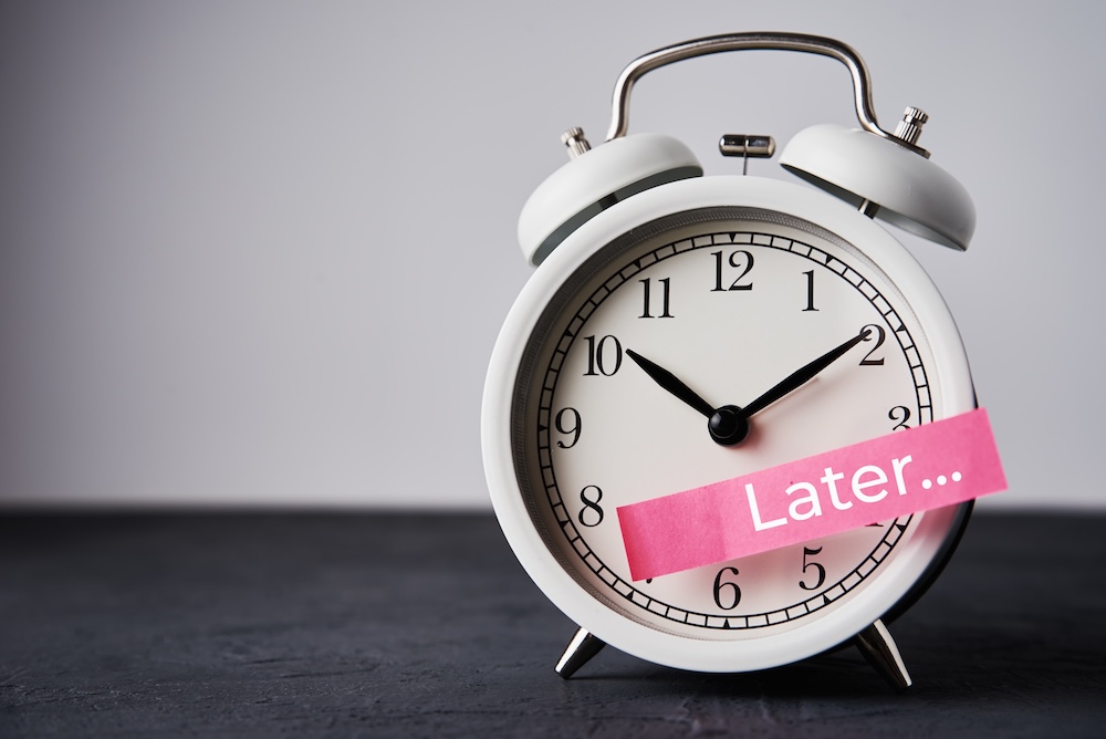 Clock with a sticker that says Later