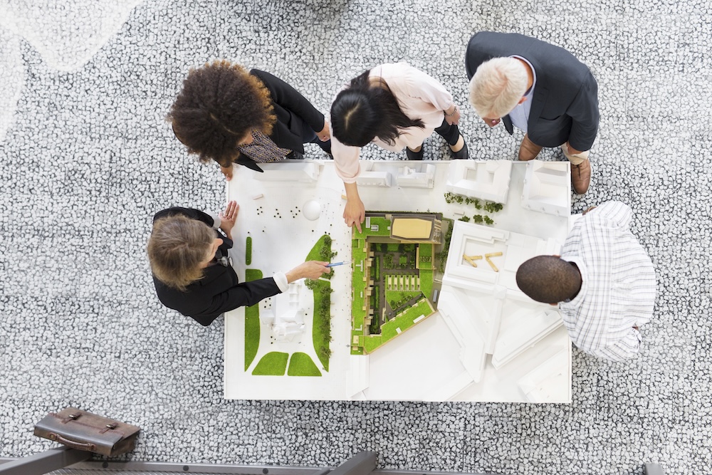 Team of professional architects designing a sustainable model